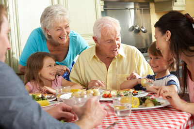 Photograph of multigenerational family gathered around the dining table