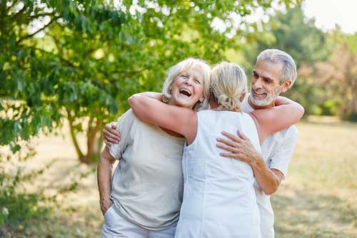 three friends hugging and smiling