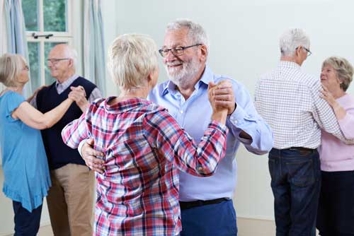 senior citizens enyoing a ballroom dance class