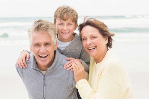 senior couple with grandson at the beach